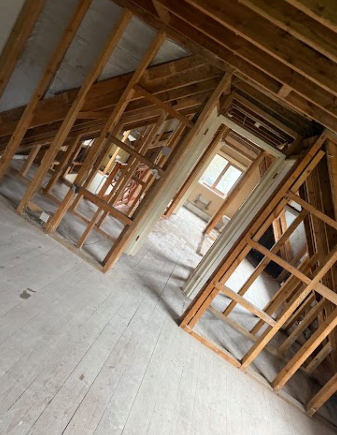 Rooms stripped back to timber framing and floorboards after an internal strip-out in Wimborne, Dorset