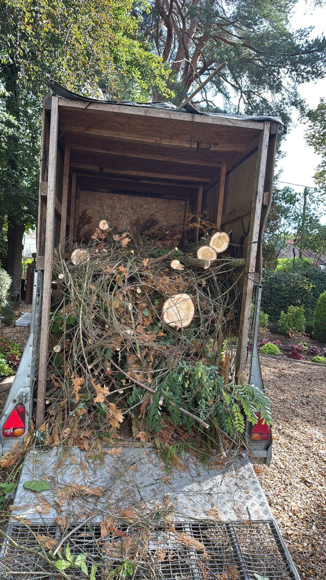 Trailer loaded with cut branches from a garden clearance job in Wimborne, Dorset