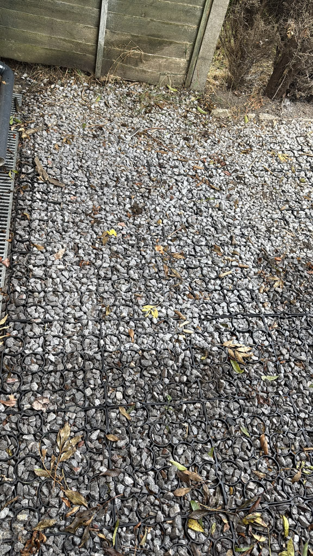 Clean gravel area beside a fence after garden waste removal in Wimborne, Dorset