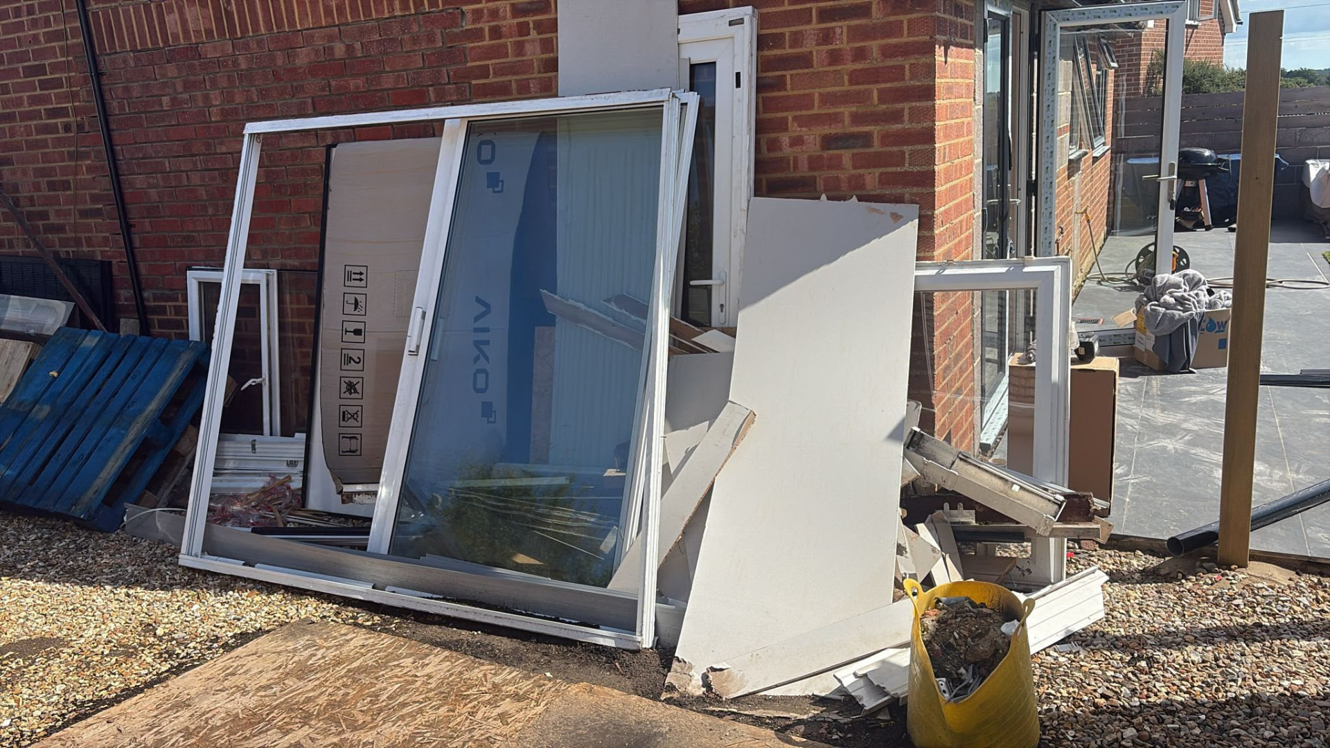 Old window frames and construction offcuts awaiting waste collection in Wimborne, Dorset