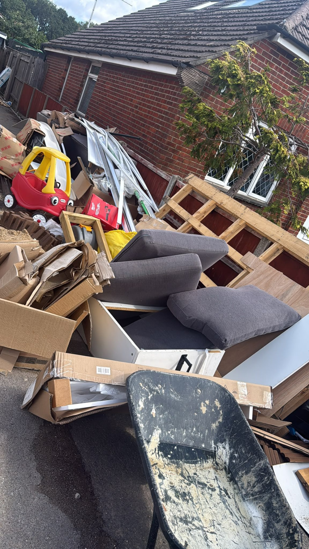 Furniture, cardboard and household rubbish awaiting waste collection in Wimborne, Dorset