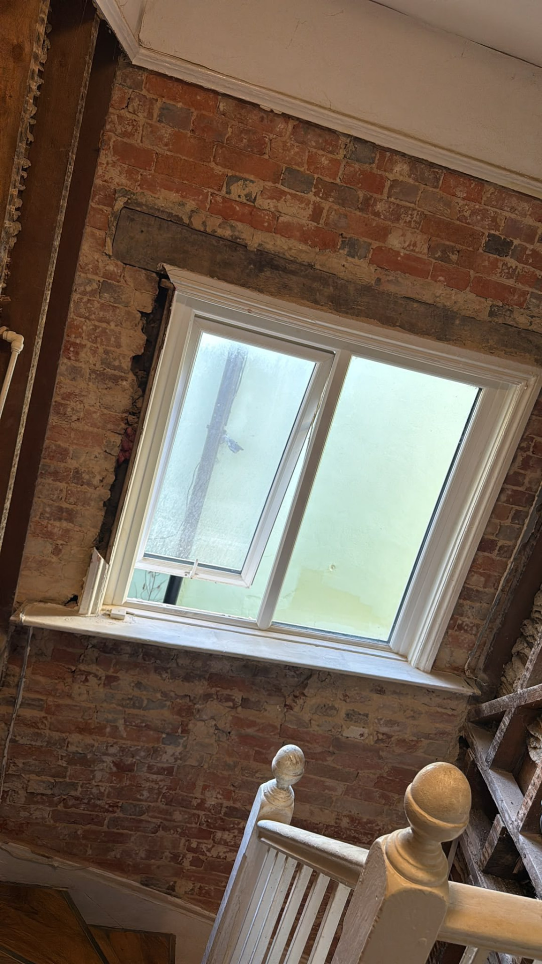 Exposed brickwork around a window after an internal strip-out in Wimborne, Dorset
