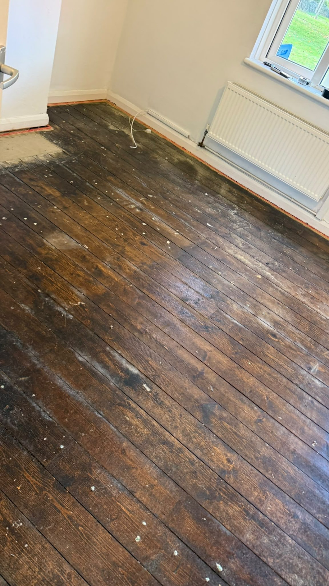 Cleared room with floorboards and radiator after house clearance in Wimborne, Dorset