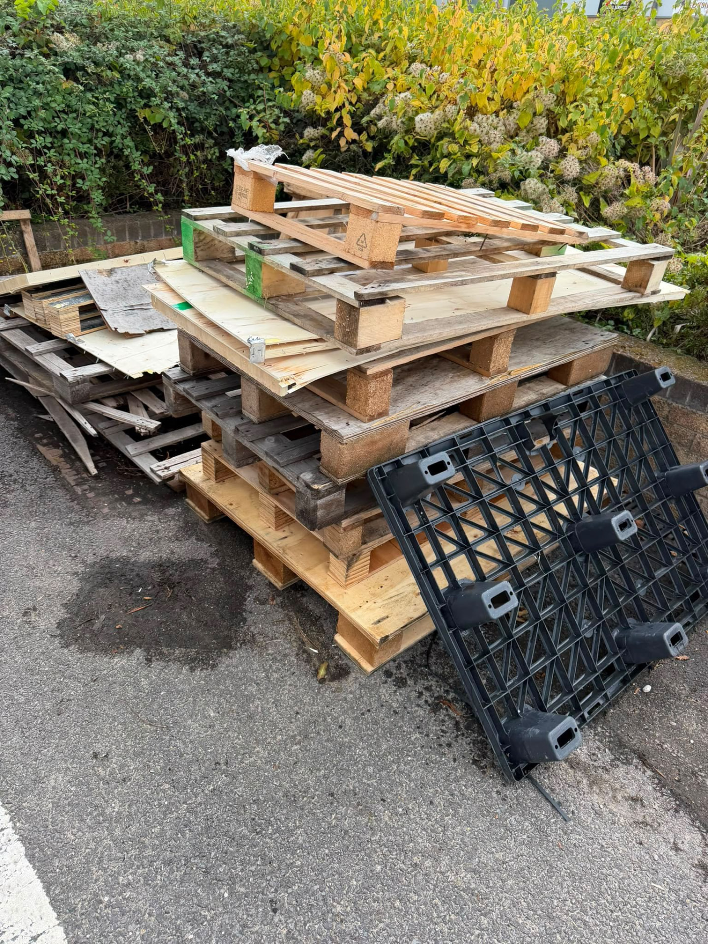 Stack of pallets and timber panels awaiting collection in Wimborne, Dorset