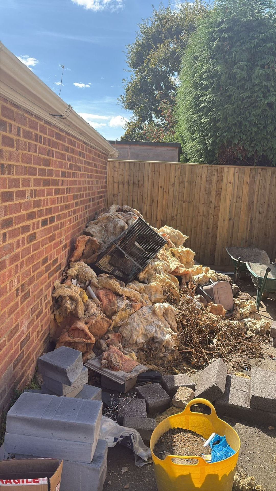 Insulation, broken blocks and debris awaiting waste collection in Wimborne, Dorset