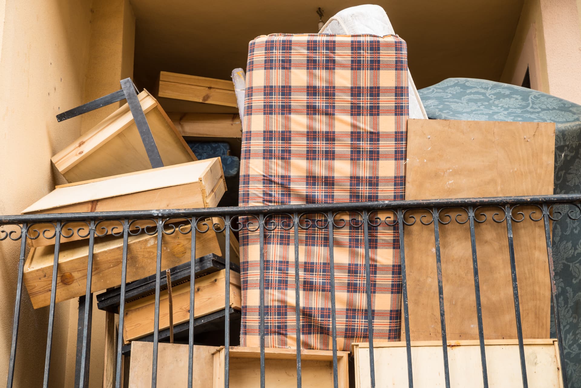 Old mattresses and wooden bed frames stacked up awaiting bed and mattress collection in Dorset