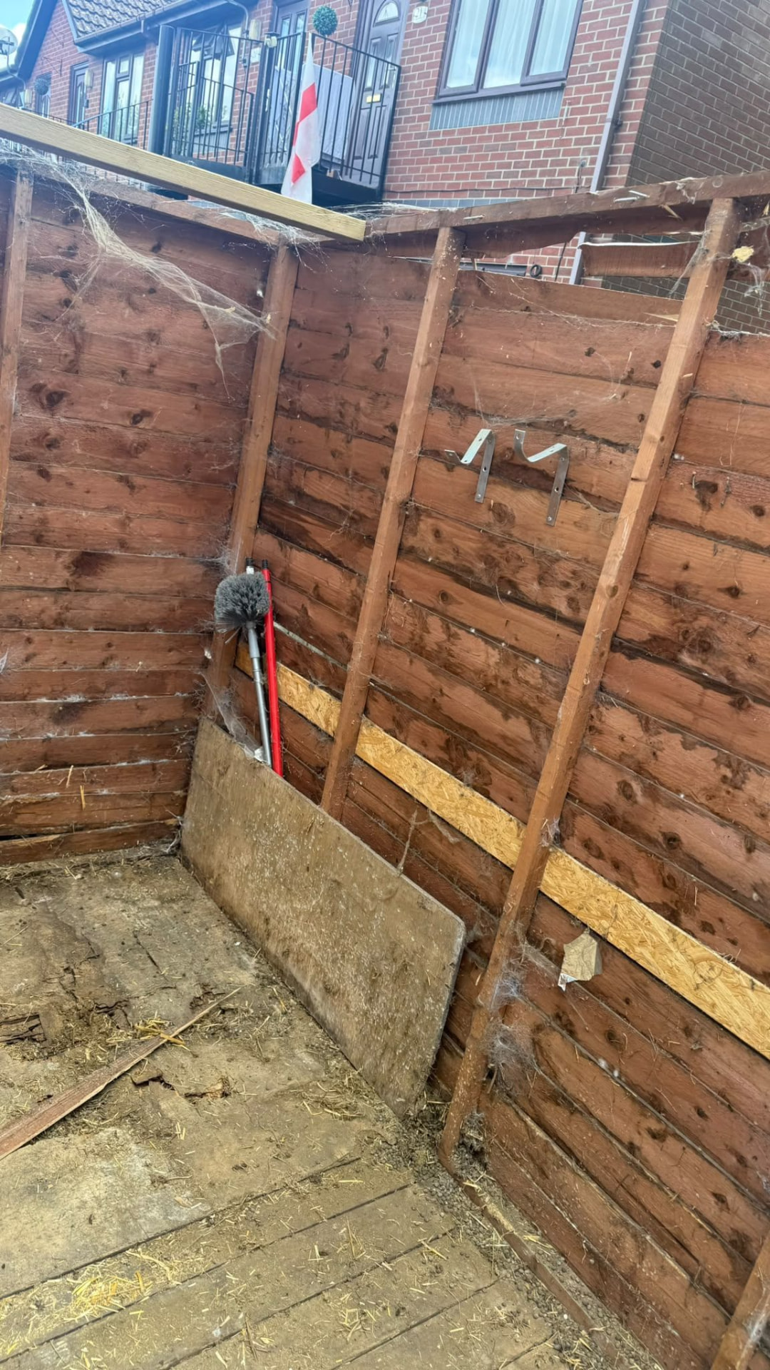Inside a weathered timber shed before demolition in Wimborne, Dorset