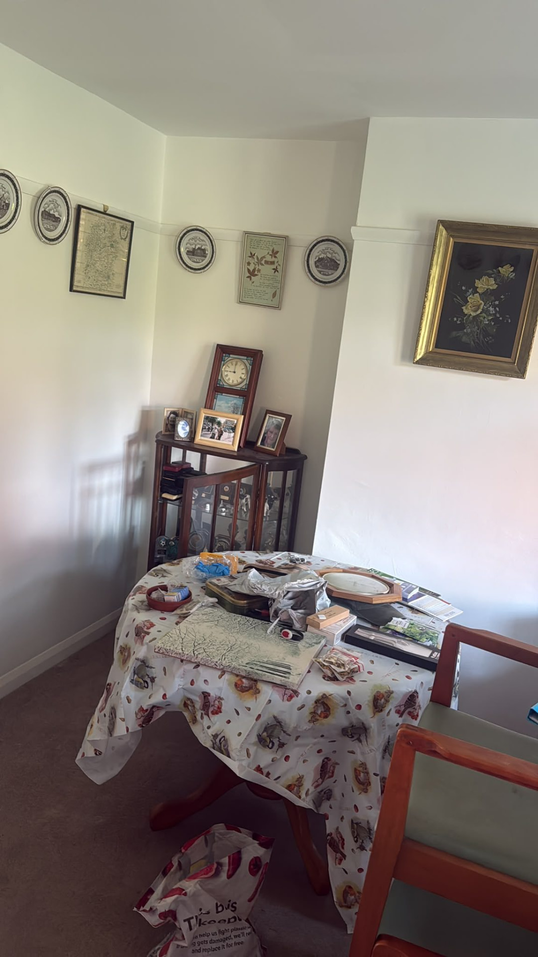 Dining room covered in belongings before a house clearance in Wimborne, Dorset