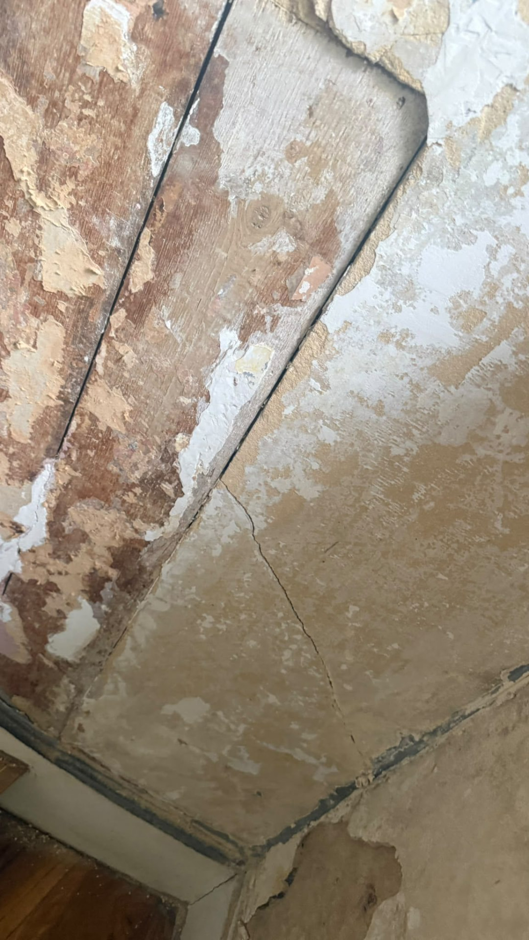 Worn plaster and exposed wall layers during internal demolition in Wimborne, Dorset