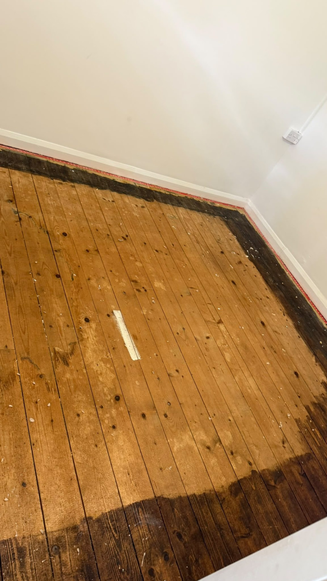 Empty room with bare floorboards after a house clearance in Wimborne, Dorset